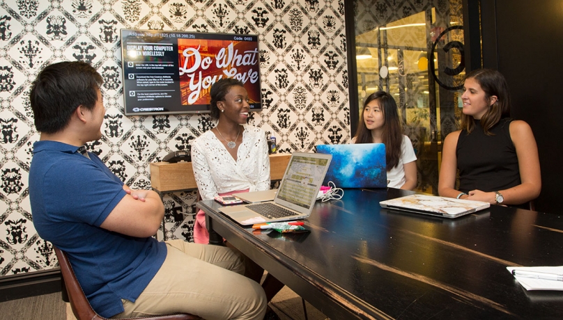 From left Amos Chiou, digital strategist at Trendalytics, talks with juniors Victoria Scott, Denise Chan and Sarah Muse, who worked at Trendalytics as part of the immersion program.