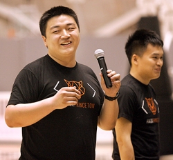 Paul Wong (speaking), of the University of Pittsburgh, teamed up with Yi Qin (right) and Jian Zhang (not shown) of Purdue University, to create SmartCar, a device to improve safety in older cars not already equipped with modern accident-avoidance technology. (Photo by Frank Wojciechowski for the Office of Engineering Communications)