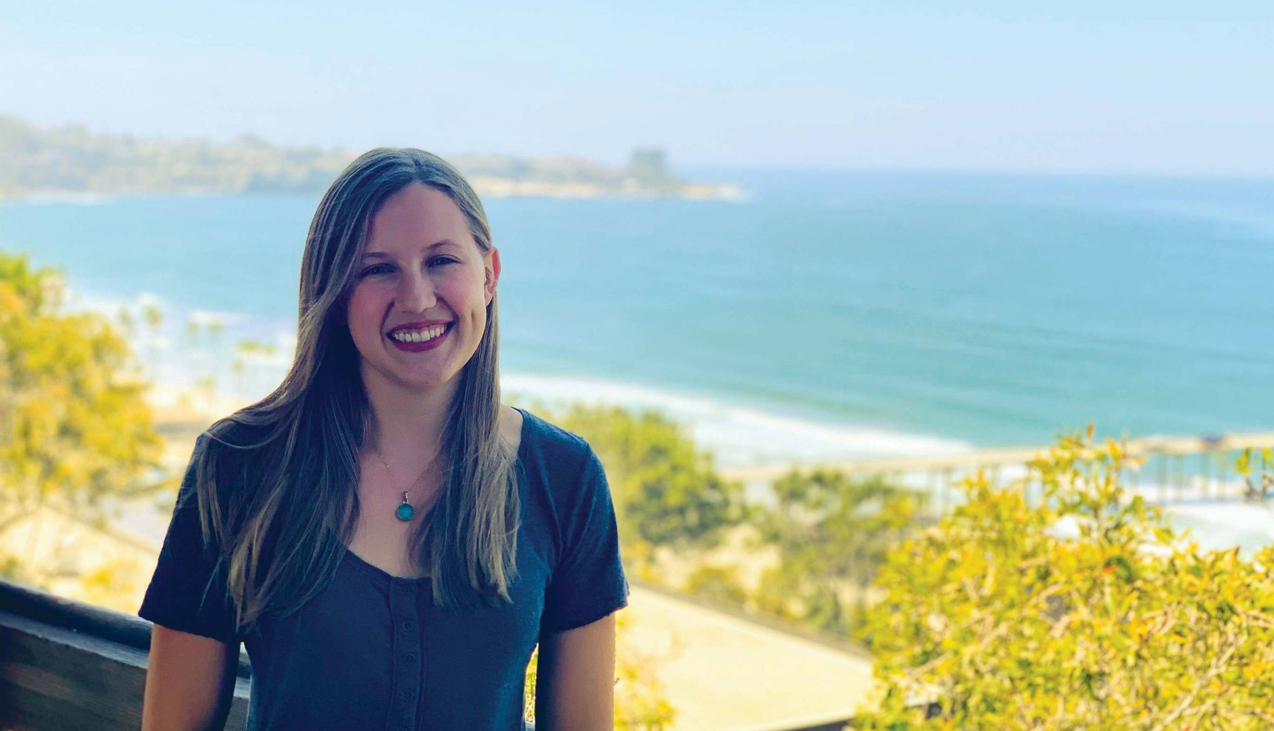 Lauren von Berg standing in front of the ocean in the distance.