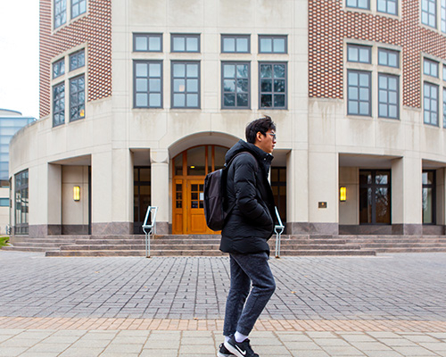 student walking in front of the computer science building